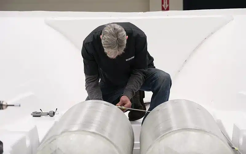 Roush engineer inspecting and working on hydrogen fuel tanks inside the Regulator Marine center console