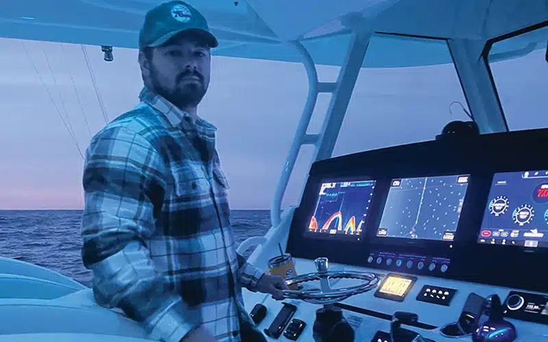 Cross Ferrara at the helm of his Regulator 41, navigating the Atlantic waters at dusk