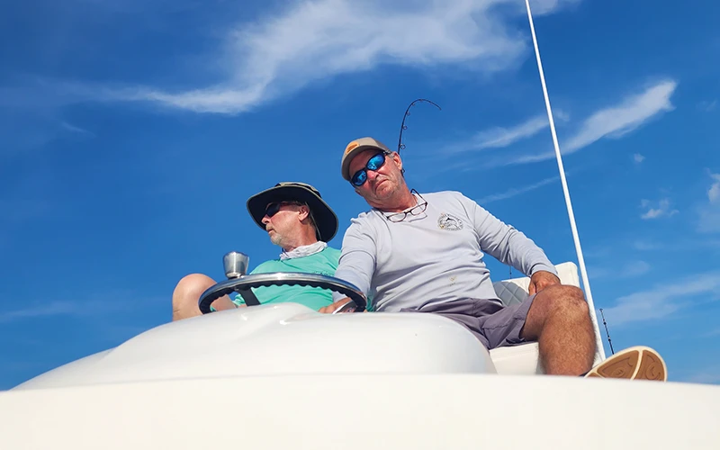 Wayne Enroughty and a friend driving from the second helm station of his Regulator 30XO, enjoying a day of fishing under clear skies