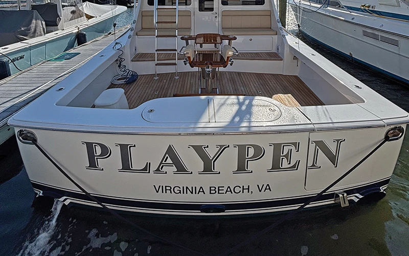 Transom view of the Viking 46 Billfish named PLAYPEN, docked at Virginia Beach, showcasing its spacious cockpit and seating area