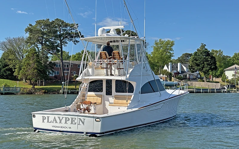 The Viking 46 Billfish underway, featuring the tower and flybridge setup with dual helm chairs, and showcasing its sleek exterior design